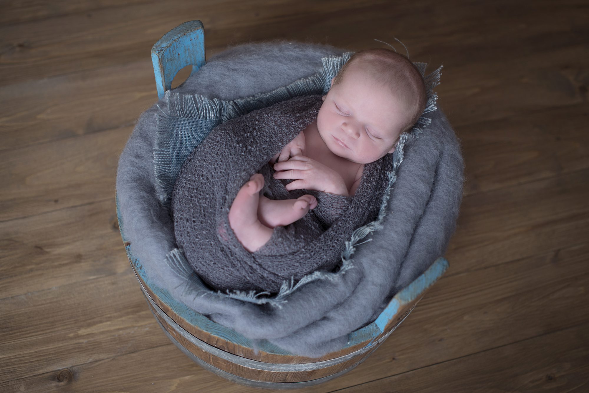 baby boy asleep on grey background in newborn photography shoot Woodley, Berkshire