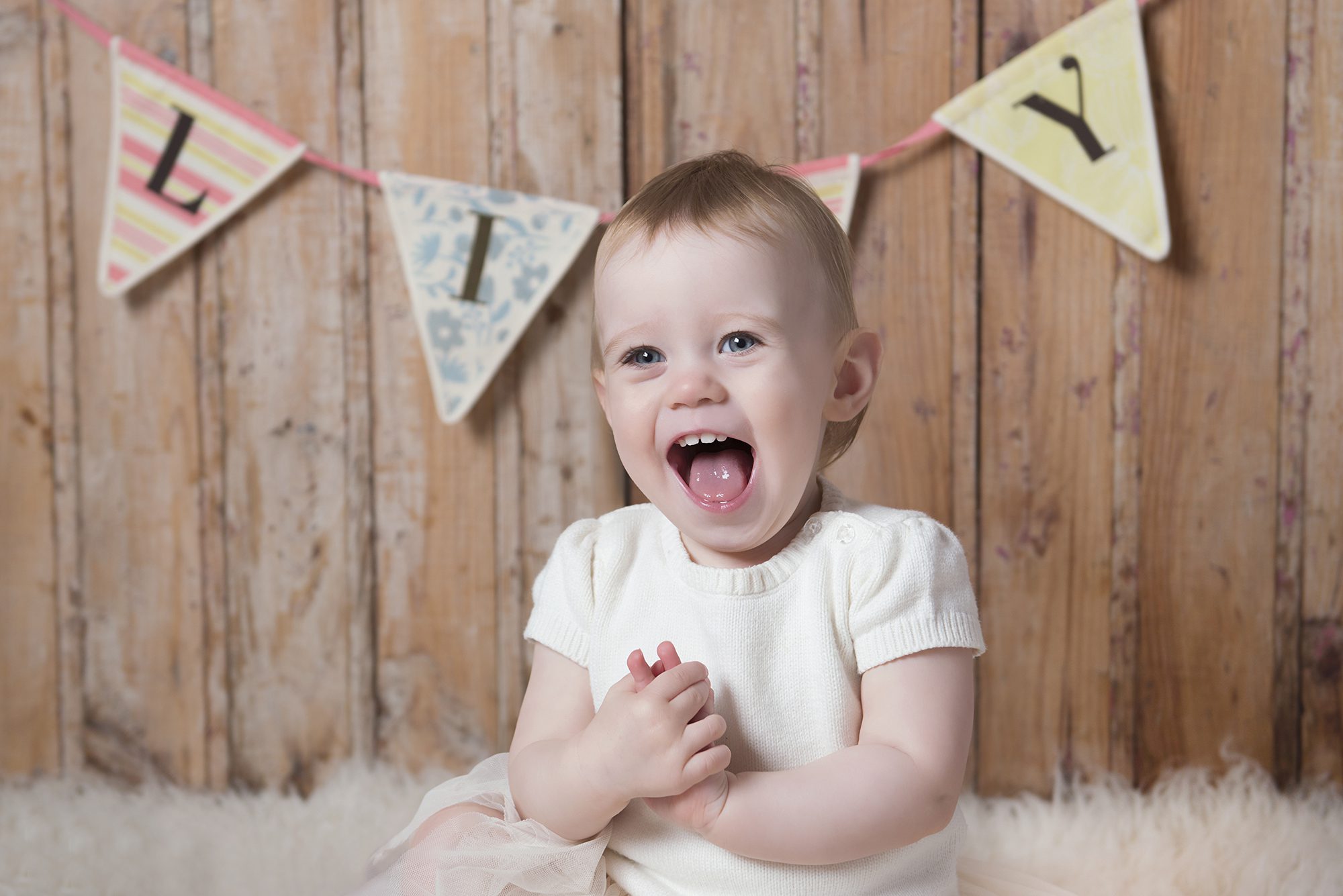 girl laughing in photoshoot by child photographer Berkshire