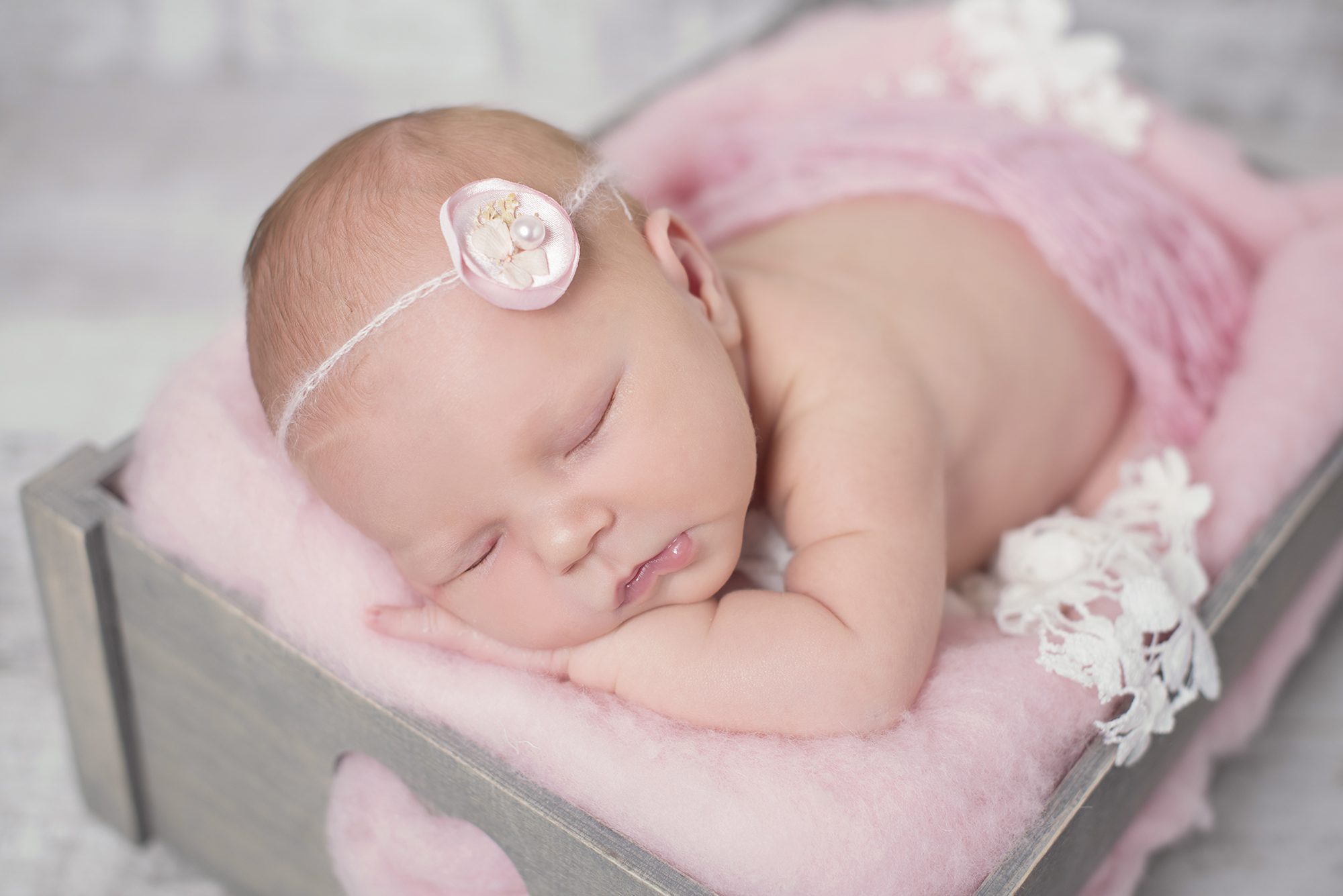 baby girl asleep on pink fluffy blanket by newborn photographer Woodley