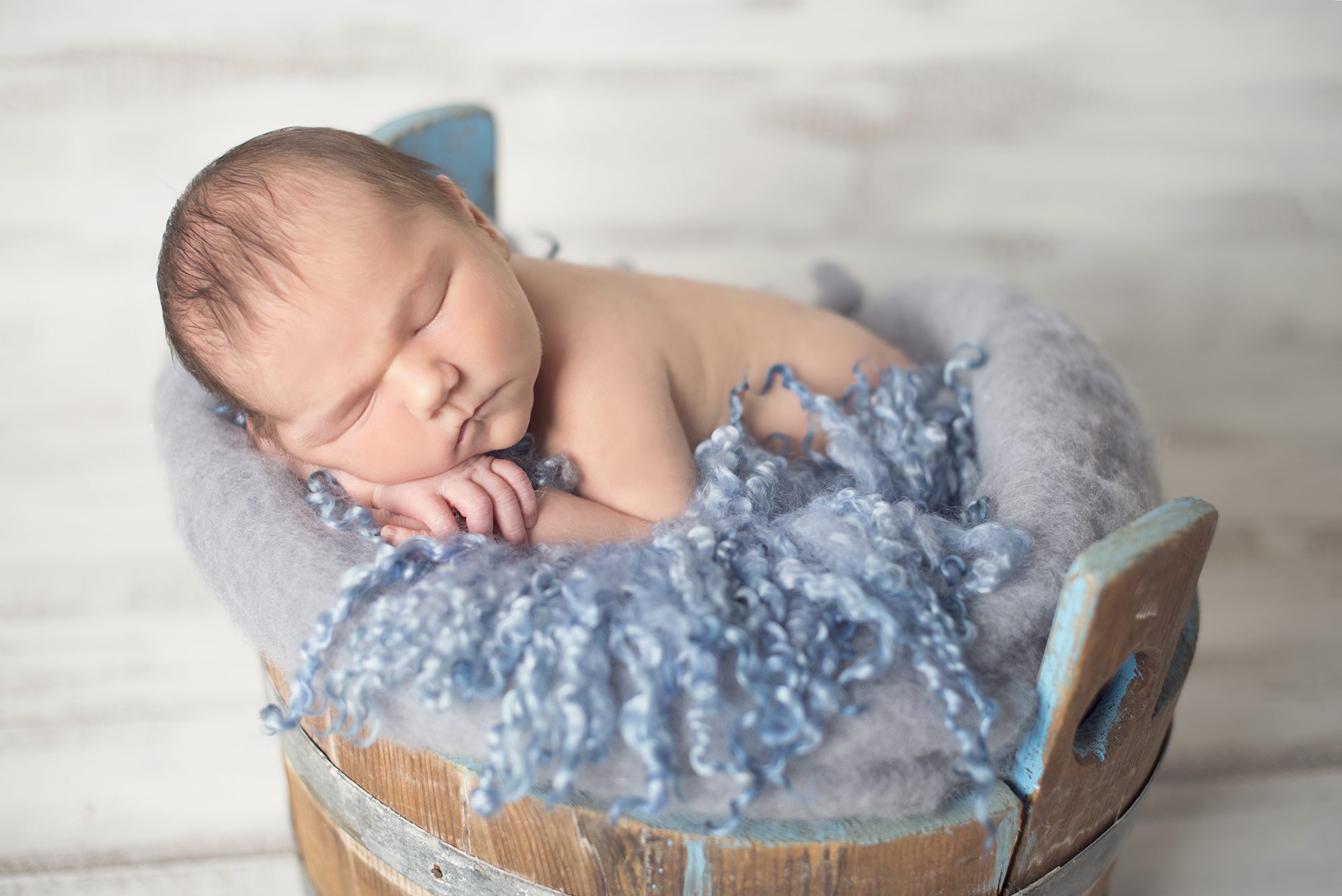 baby sleeping in blue tub in newborn photoshoot Twyford, Wokingham