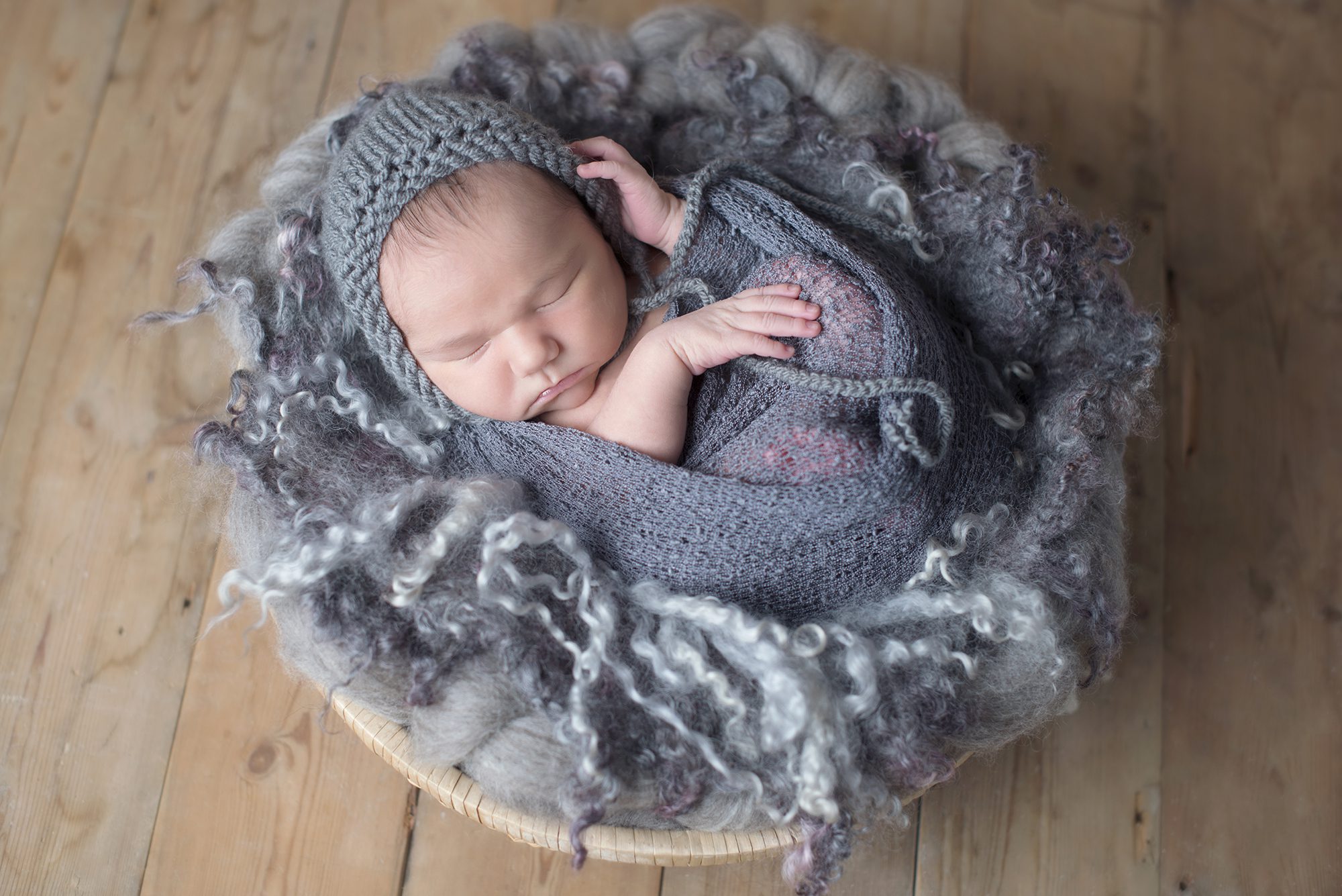 baby boy wrapped in grey by newborn photographer Woodley