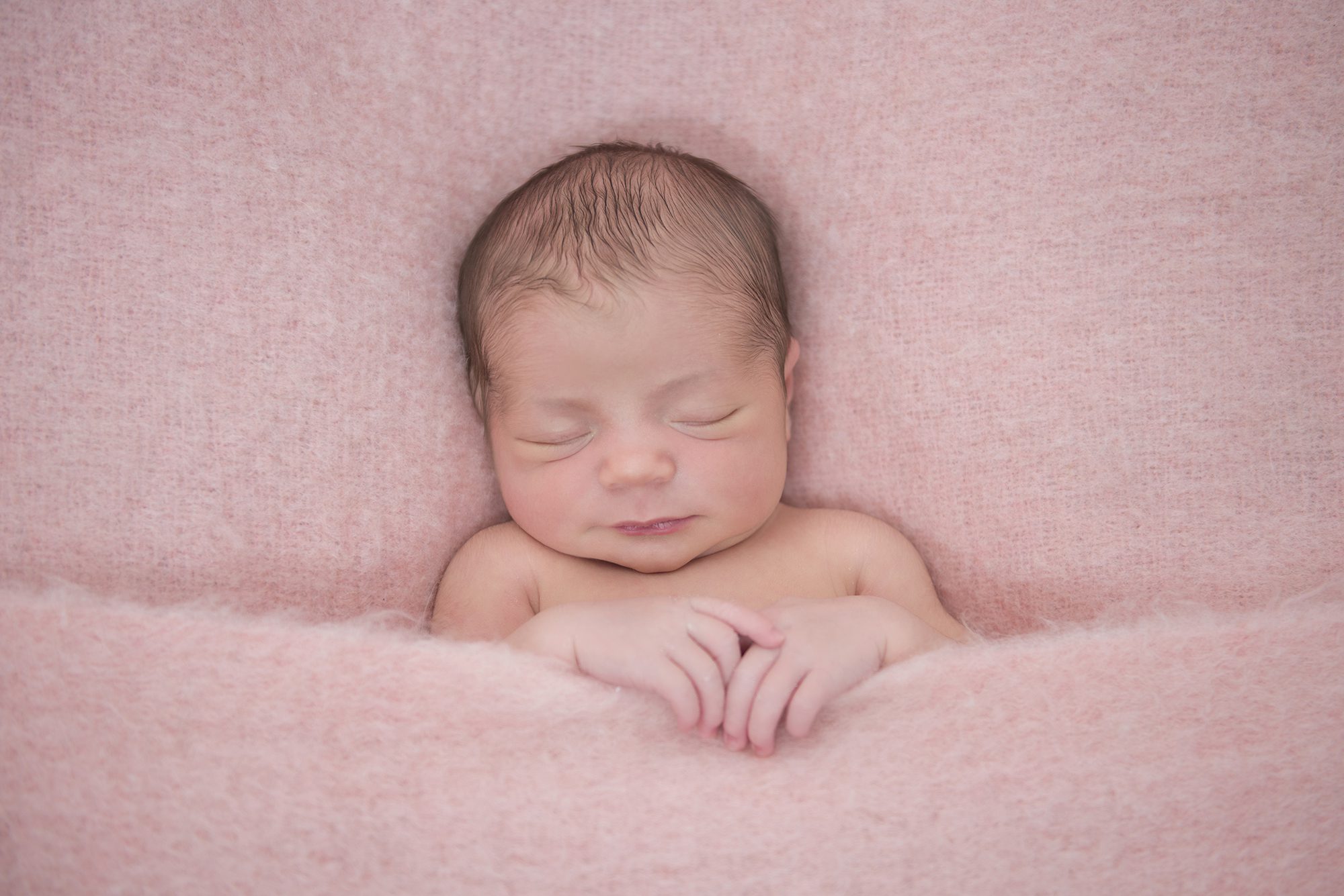 baby in pink blanket in newborn photography session Wargrave