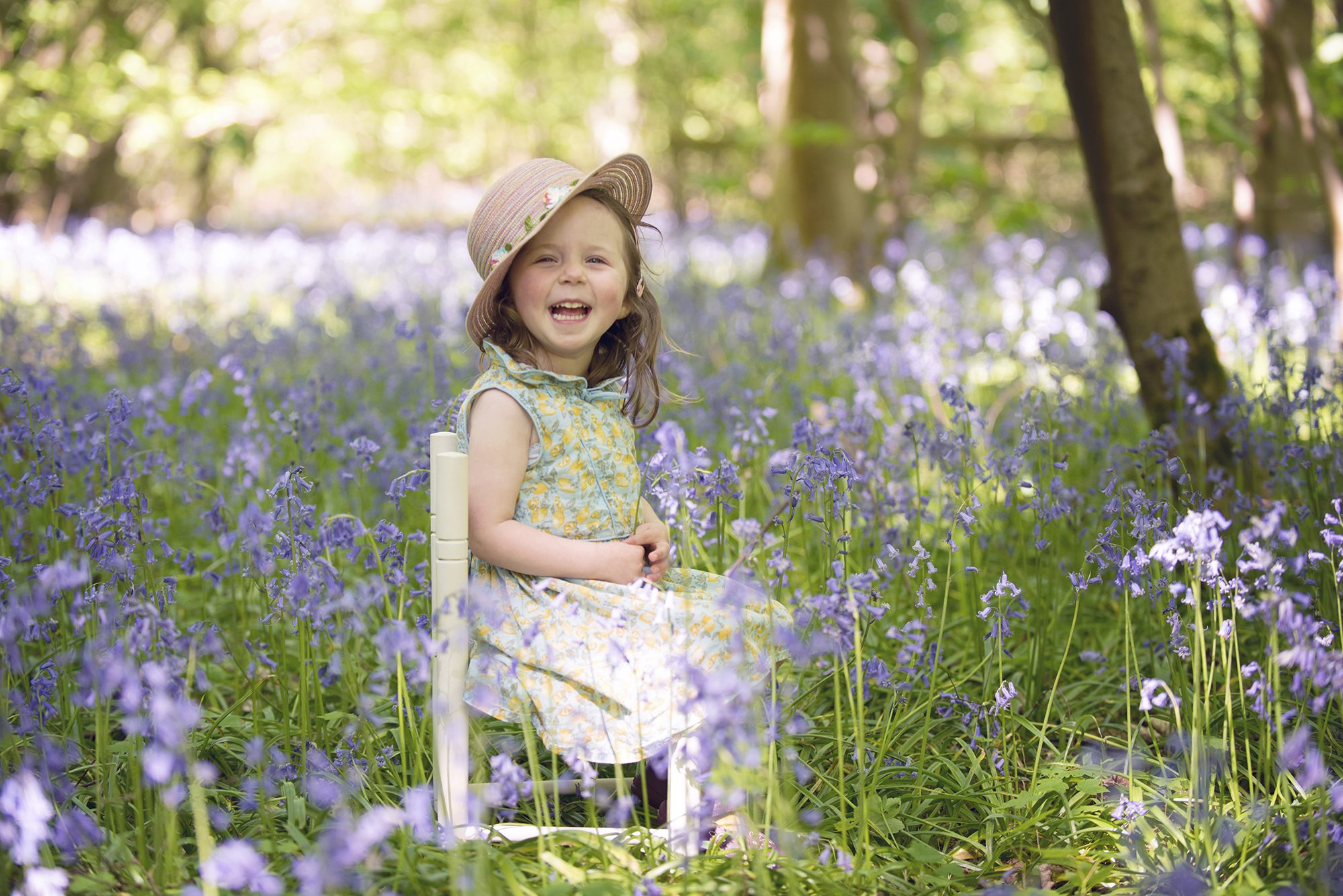 little girl laughing in bluebells, child photography session
