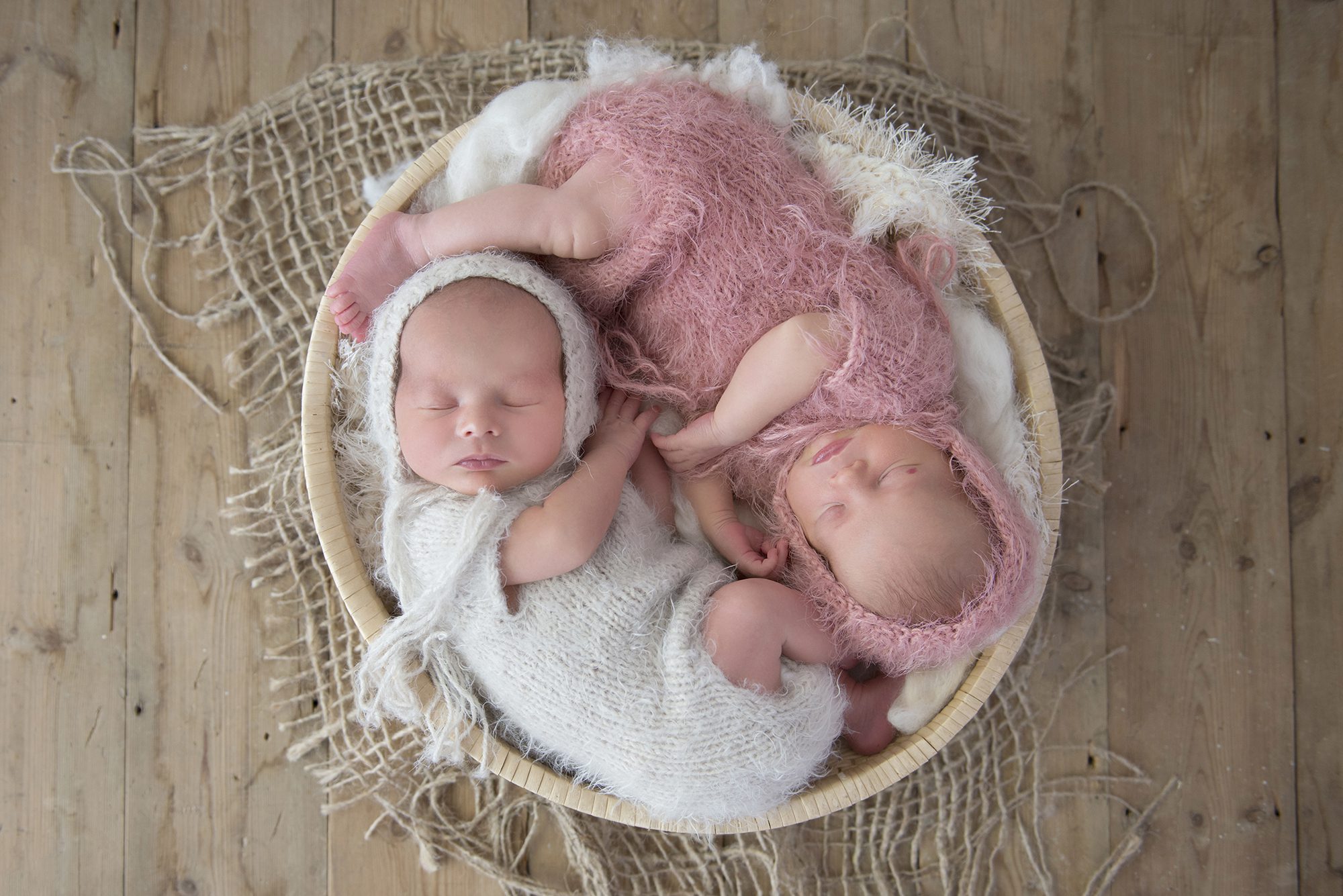 twin babies curled up in basket together in newborn photography session Twyford Wokingham