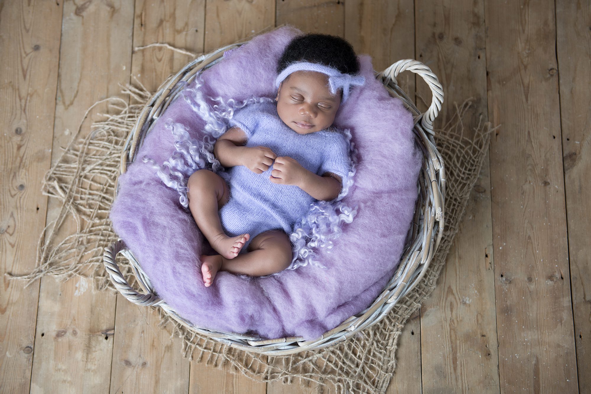 baby sleeping in basket in photography session Woodley, Berkshire