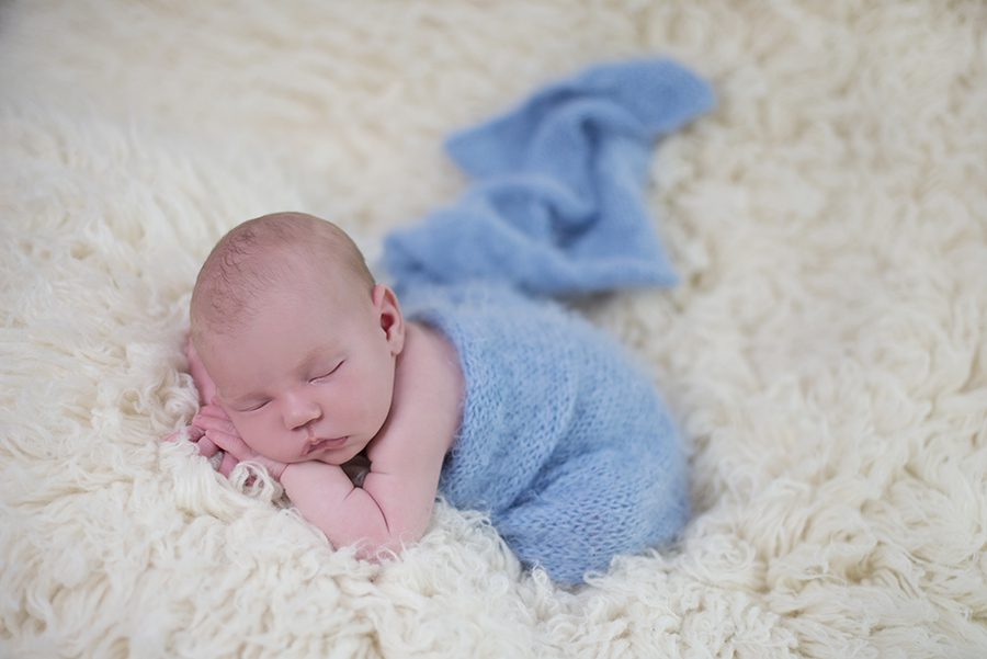 baby asleep on fur blanket photographed by newborn baby photographer Berkshire