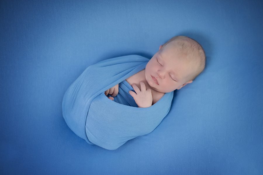 Newborn baby in blue wrap photographed by photographer Maidenhead, Berkshire