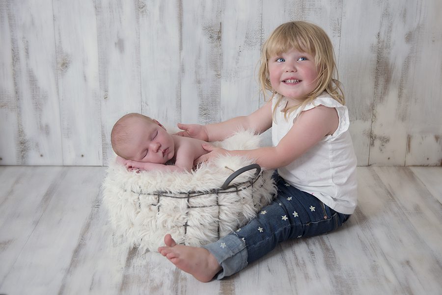 Newborn baby and big sister by newborn photographer Berkshire