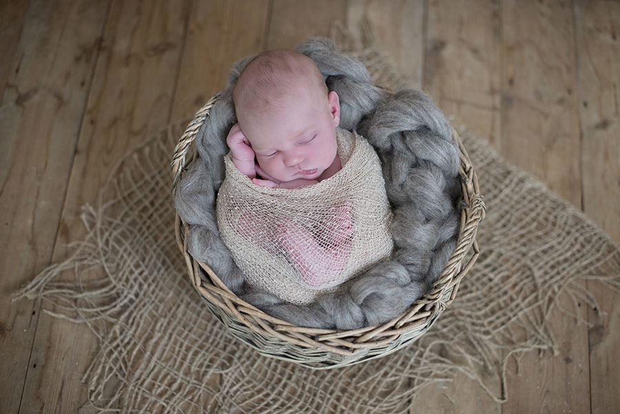 newborn baby sleeping in basket in newborn photography session Twyford, Wokingham