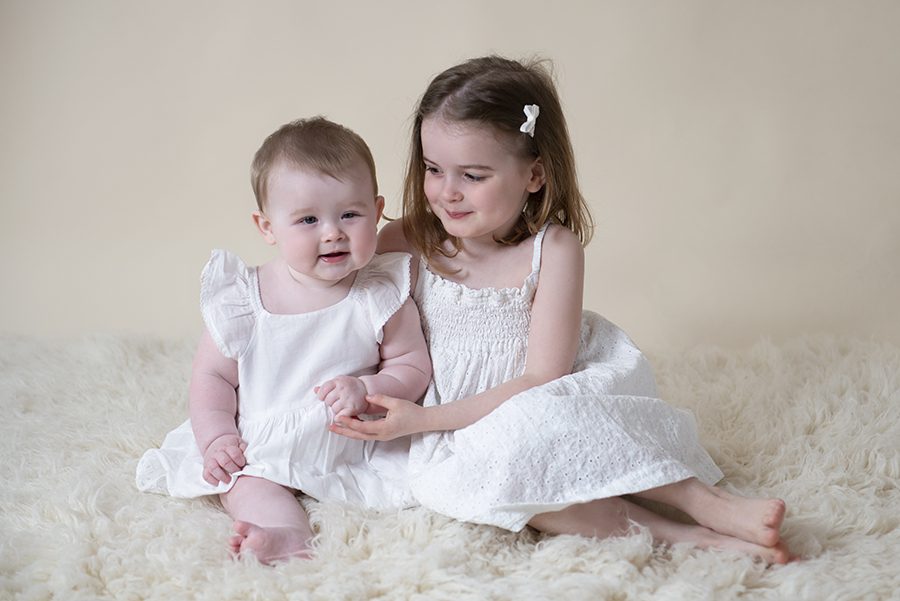 sisters hugging, baby and child photography Reading, Berkshire