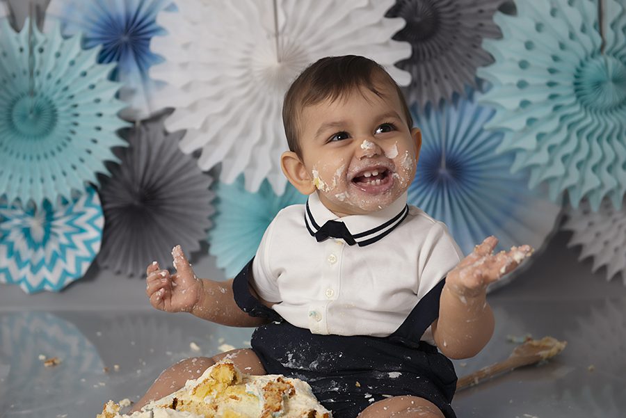 baby boy eating cake for cake smash photography session